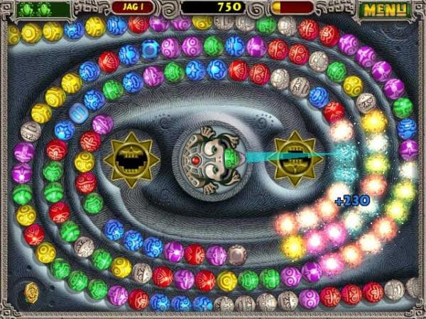 Screenshot from Zuma game: a stone frog shoots colorful marbles at other marbles