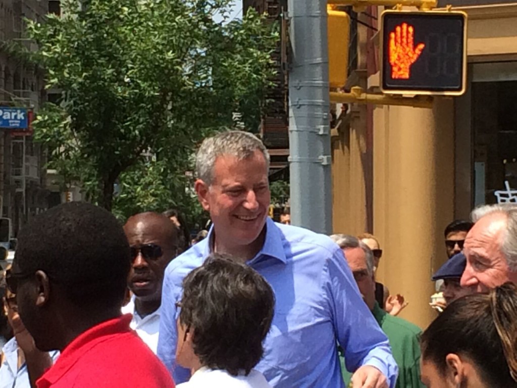 New York City Mayor Bill de Blasio speaks with people in the street