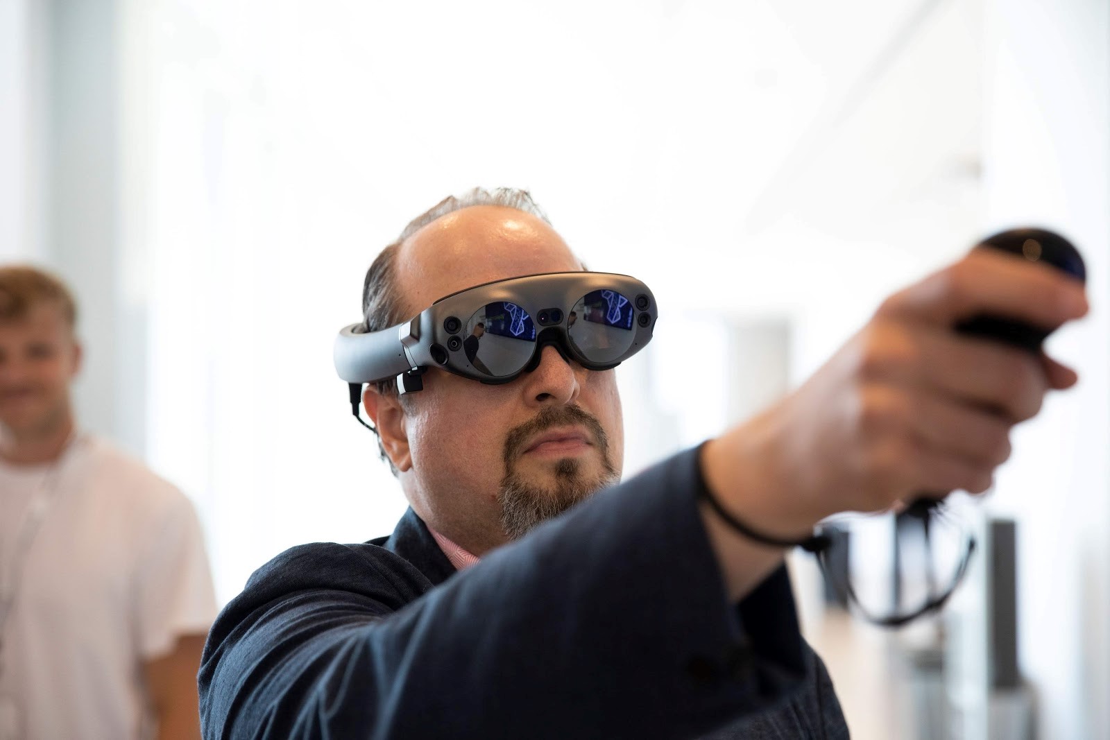 Bill Curtis-Davidson (former Accessibility Leader at Magic Leap) points a 6DoF controller while wearing a Magic Leap 1 spatial computing device during the 2019 XR Access Symposium in New York, July 2019.