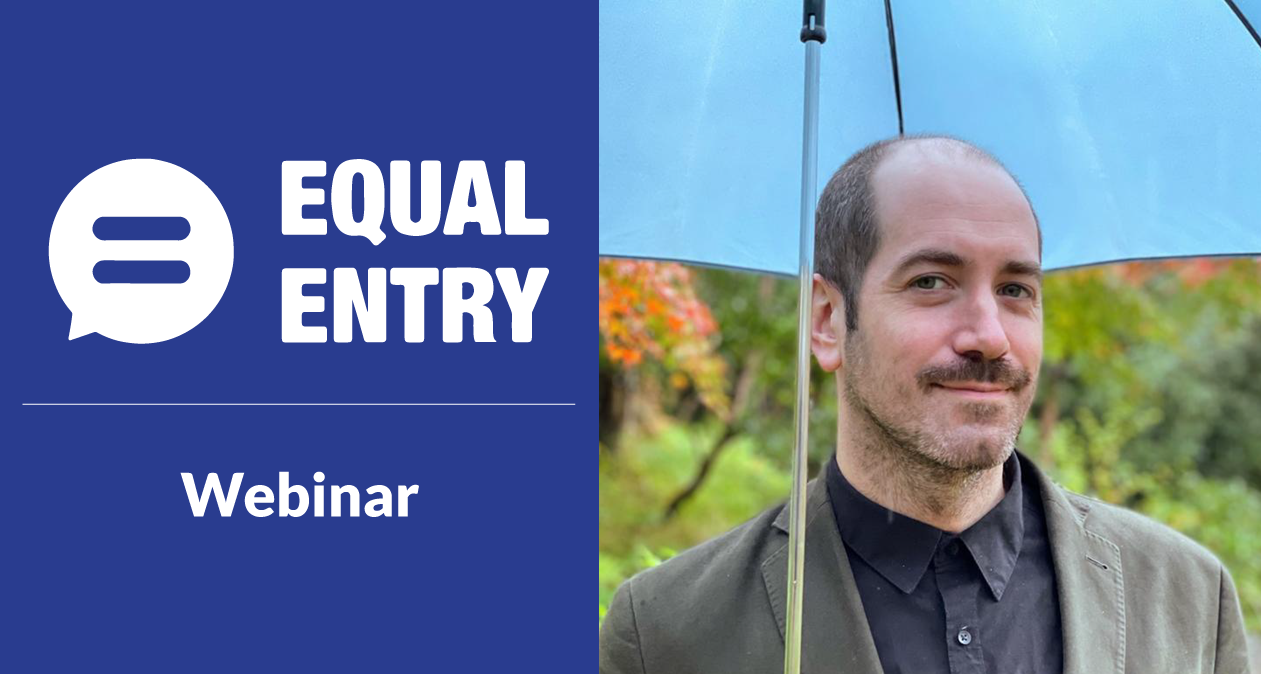 Equal Entry Webinar with Thomas Logan holding an umbrella and wearing a jacket with a dark buttoned-up shirt