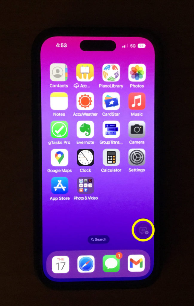 iPhone screen with Live Caption button barely visible