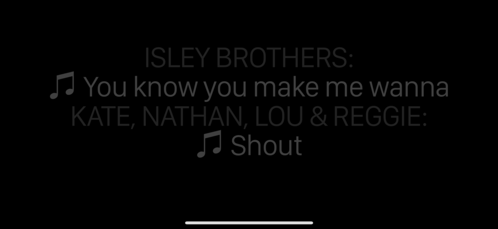Screenshot of captions showing "Isley Brothers: You know you make me wanna. Kate, Nathan, Lou & Reggie: Shout" with speaker identification in a faint gray and song lyrics in brighter gray.
