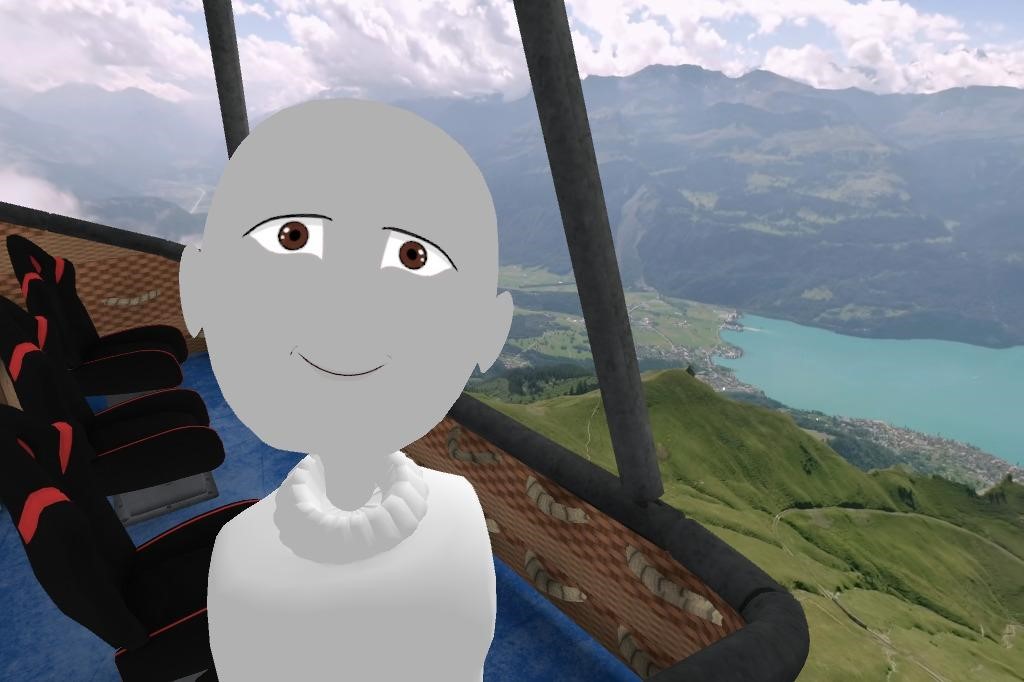 髪の毛の無い灰色のデフォルトアバターがこちらを向いて熱気球から自撮りをしている。後ろにはスイスの風景が広がっている。