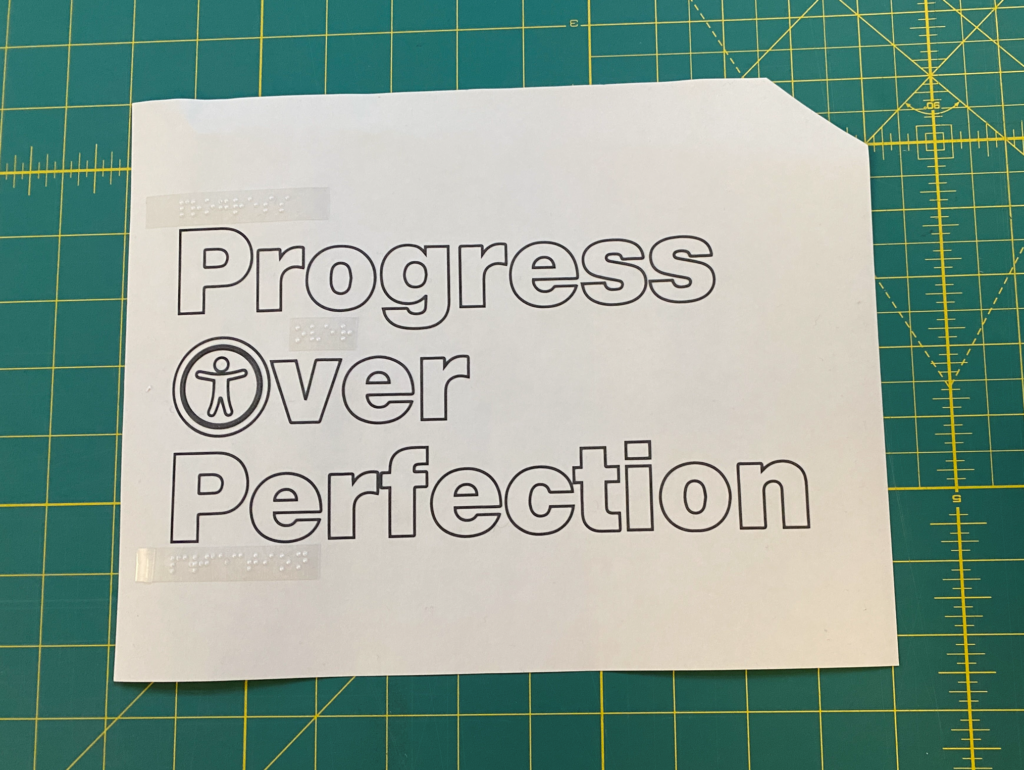 Outline version of "Progress Over Perfection" with the accessibility icon in Over's O and a missing top-right corner. Clear Braille labels appear above each word they match.