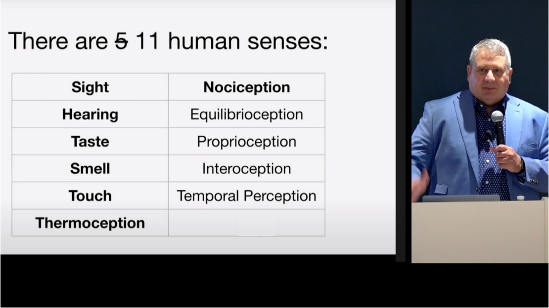 Screenshot of Joe Devon with slide about the 11 human senses: Sight, Hearing, Taste, Smell, Thermoception, Nociception, Equilibrioception, Proprioception, Interoception, Temporal Perception